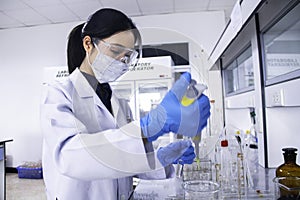 Scientist working at a lab with micro pipette and test tubes.
