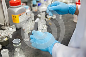 Scientist working in laboratory mixing liquids