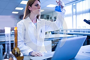 Scientist working with a laptop in laboratory