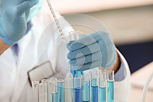 Scientist working with samples in test tubes, closeup