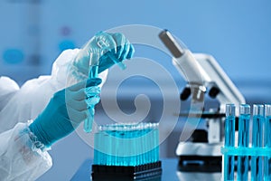 Scientist working with test tubes in laboratory, closeup