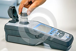 Scientist working at water quality test use by Spectrophotometer