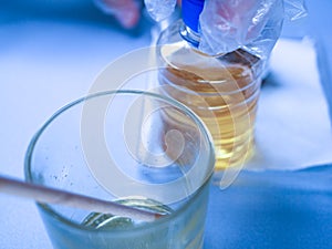 Scientist works with harmful chemicals. A laboratory worker examines biologically hazardous liquids, hazardous work, chemistry.