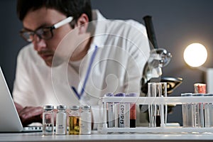 Scientist at workspace in laboratory with microscope, computer, and laboratory tools. Bio technology. Med students stuff. Medical