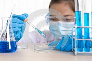 Scientists are carrying blue chemical test tubes to prepare for the determination of chemical composition and biological mass in a