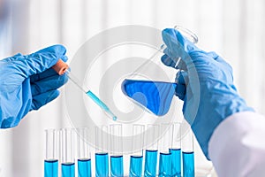 Scientists are carrying blue chemical test tubes to prepare for the determination of chemical composition and biological mass in a