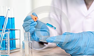 Scientists are carrying blue chemical test tubes to prepare for the determination of chemical composition and biological mass in a