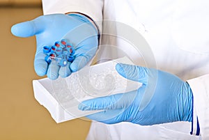 Scientists hand holds disposable caps