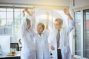 Scientists hands rais up,Group of diversity people teamwork in laboratory,Success and reserch working