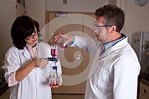 Scientists holding labware