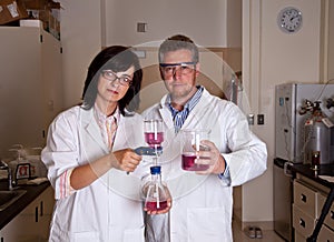 Scientists holding labware