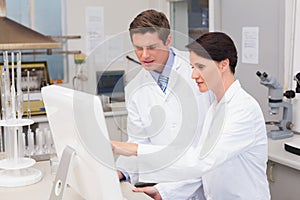 Scientists looking attentively at computer