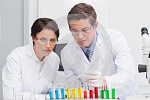 Scientists looking attentively at test tube