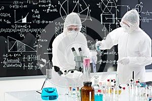 Scientists manipulating lab tools