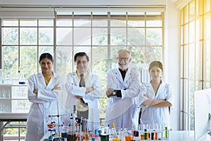 Scientists standing and cross arms,Group of diversity people teamwork in laboratory,Success and reserch working photo