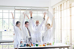 Scientists team raise up your hand,Group of people teamwork in laboratory,Successful and reserch working photo