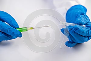 Scientists wearing masks and gloves Holding a syringe with a vaccine to prevent covic-19