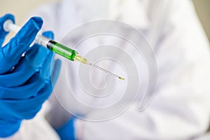 Scientists wearing masks and gloves Holding a syringe with a vaccine to prevent covid-19