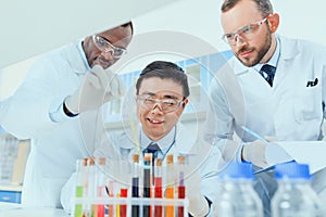 Scientists in white coats working together in chemical laboratory