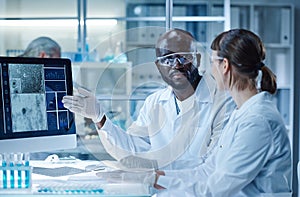 Scientists working with computer in team