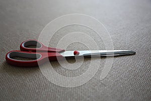 Scisors with red plastic handle