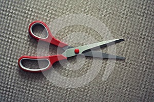 Scisors with red plastic handle