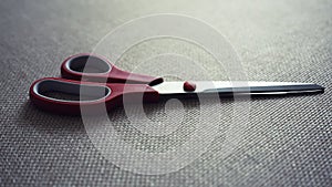 Scisors with red plastic handle