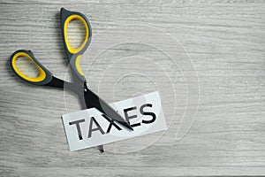 Scissor Cutting the Word Taxes.