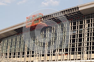 Scissor elevated lift platform. Multi-storey with many glass Windows .background of glass windows of modern office building .