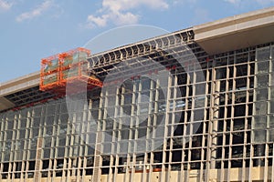 Scissor elevated lift platform. Multi-storey with many glass Windows .background of glass windows of modern office building .