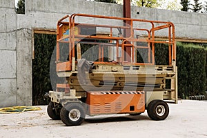 Scissor Lift Platform on a construction site near the wall