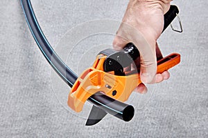 Scissor style cutter for cutting of plastic pipe and tubing.