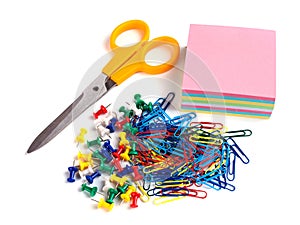 Scissor, tacks, papers and paper clips on white background