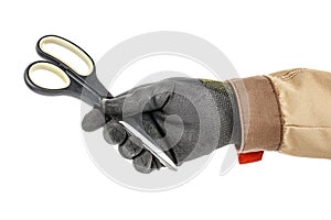 Scissors with black plastic handles in worker hand in black protective glove and brown uniform isolated on white background