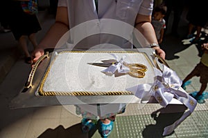 Scissors for the ceremonial ribbon-cutting at the opening ceremony on the white cushion and tray with handles