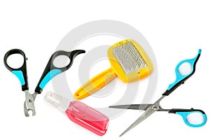 Scissors, clipper, shampoo and comb for dog grooming isolated on a white background