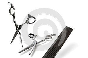 Scissors and comb on white background, copy space