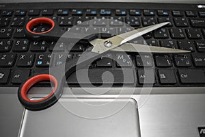 Scissors on computer keyboard