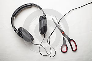 Scissors cut the wire from the headphones, and thus stop the very loud illegal pirated music