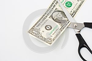 Scissors cuts one american dollar note