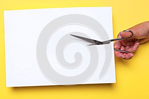 Scissors cutting blank paper