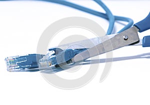 Scissors cutting the blue ethernet cable