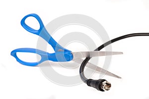 Scissors cutting through a coaxial RG6 cable