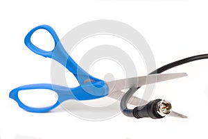 Scissors cutting through a coaxial RG6 cable