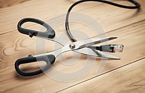 Scissors cutting internet cable.