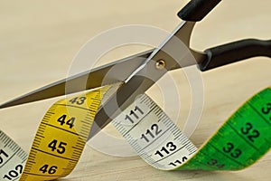 Scissors cutting measuring tape - Concept of dieting and slimming