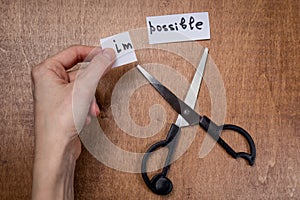 Scissors cutting negative label, self motivation concept