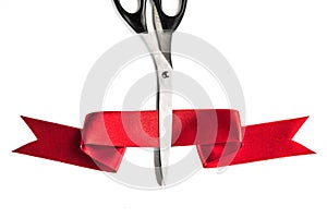 Scissors cutting red ribbon