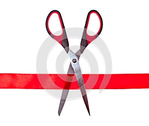 Scissors cutting through red ribbon