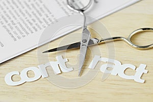 Scissors cutting the word Contract - Contract termination concept